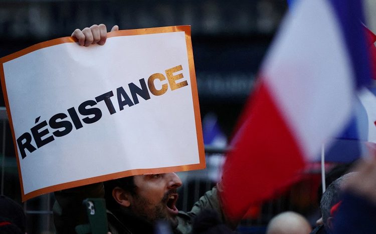 People attend a demonstration called by French political party "Les Patriotes" against COVID-19 vaccine pass as French lawmakers attend a debate on the French government's planned bill to transform the current health pass into a vaccine pass, at the National Assembly in Paris, France, January 3, 2022. REUTERS/Sarah Meyssonnier
