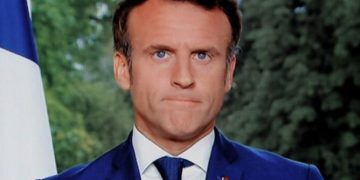 A photo of a TV screen shows French President Emmanuel Macron speaking during televised address on June 22, 2022, in Paris. - President Emmanuel Macron made a televised address on June 22, his first public statement since his centrist party lost its parliamentary majority in elections. His address will come after meetings with the heads of most French political parties, including the far-right and far-left groupings that saw significant gains in parliament, potentially halting Macron's reformist agenda (Photo by Ludovic MARIN / AFP)
